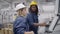 African American female factory engineer teaching employee