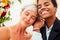 African american female groom in black suit and happy caucasian blonde bride loving together on beach ceremony under