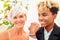 African american female groom in black suit and happy caucasian blonde bride loving together on beach ceremony under