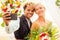 African american female groom in black suit and happy caucasian blonde bride loving together making selfie photo on