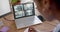 African american female security officer watching business cctv camera views on laptop, slow motion