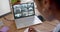 African american female security officer watching business cctv camera views on laptop, slow motion