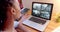 African american female security officer watching business cctv camera views on laptop, slow motion