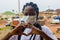 African American female wearing a sanitary face mask while standing outdoors during isolation