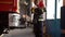 African American fire fighter in equipment holding little girl at station