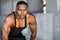 African american fitness and sport head shot portrait in tank top in gritty urban concrete background with copy space