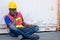 African American foreman or container worker sit and look like sleep to relax after finish his work in workplace