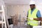 African american foreman examines documents and plans a workflow for repairs