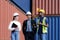 African american foreman is explaining the various sections of the container depot terminal to a caucasian man manager, with a