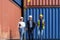 African american foreman is explaining the various sections of the container depot terminal to a caucasian man manager, with a