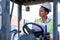 African American foreman woman or cargo container worker sit on cargo car and look to left side also thinking action during