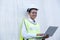 African American foreman woman hold laptop and lean on white cargo container also smile with look at camera in shipping area