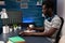 African american freelancer man sitting at desk table analyzing global economy