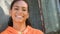 African American girl biracial teenager young woman outside thinking, smiling and laughing in an urban city