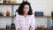 African American girl smiling bashfully at camera at home