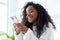 African American Girl using iPhone 12 smartphone pressing finger, reading social media internet, typing text or shopping