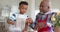 African american grandfather and grandson high fiving, planting flowers on balcony, slow motion