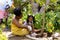 African american grandmother and granddaughter digging dirt with tools while gardening in yard