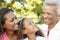 African American Grandmother, Mother And Daughter Relaxing In Park