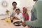 African american grandparents cooking with smiling grandson and granddaughter in kitchen