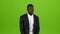 African american guy dances in a business suit, he has funny moves. Green screen