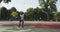 African american guy playing basketball, throwing ball into basketball hoop