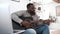An African American guy is playing guitar