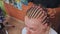 African American hairdresser coiffeur weaves French braids, bride\'s hairstyle.