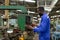 African american industry worker control machines in the workplace on a business day