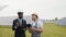 African american inspector with tablet in hands giving instruction to indian technician about work on solar plant