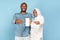 African American Islamic Couple Showing Phone Empty Screen, Blue Background