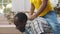 African-American kid boy piggyback ride on daddy back play together feel happy. Realtime