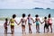 African American, Kids group in swimwear enjoying running to play the waves on beach. Ethnically diverse concept. Having fun after