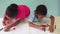 African American kids learning how to draw with crayon on table