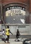 African American kids walk by a NYC building painted.
