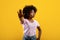 African american lady gesturing STOP, showing rejection gesture on yellow studio background