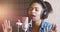 African american lady singing song at professional sound record studio, slow motion