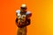 African american male american football player holding ball with neon orange lighting