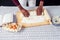 African American male cook chef boasts pastry hands in flour baking .man s hands dough rolling pin bakes cake ,eggs and
