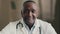 African american male doctor practitioner therapist psychologist looking at camera calling distant consult patient in