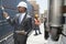 African American male engineer inspecting planks while female worker standing by flatbed truck