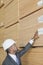 African American male engineer inspecting wooden planks