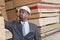 African American male engineer inspecting wooden planks