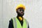 African American male engineer in safety helmet, reflective vest and eyeglasses