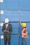 African American male engineer working on tablet PC while female industrial worker checking wooden planks