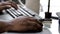 African American male hand using a computer mouse and keyboard
