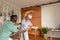 African american male physiotherapist helping caucasian senior woman to perform stretching exercise