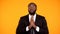 African-american male in suit praying and looking up, faith, asking for success