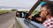 African american man adjusting side rear view mirror while sitting in convertible car