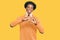 African american man with afro hair wearing cervical neck collar smiling in love doing heart symbol shape with hands